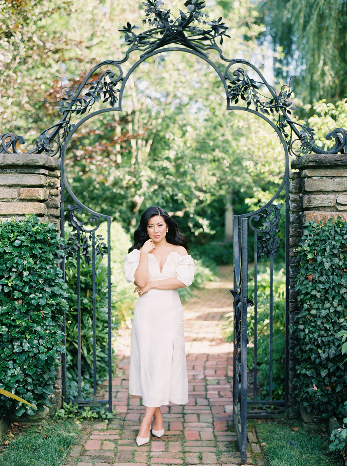 A couple poses for their engagement session in a garden.