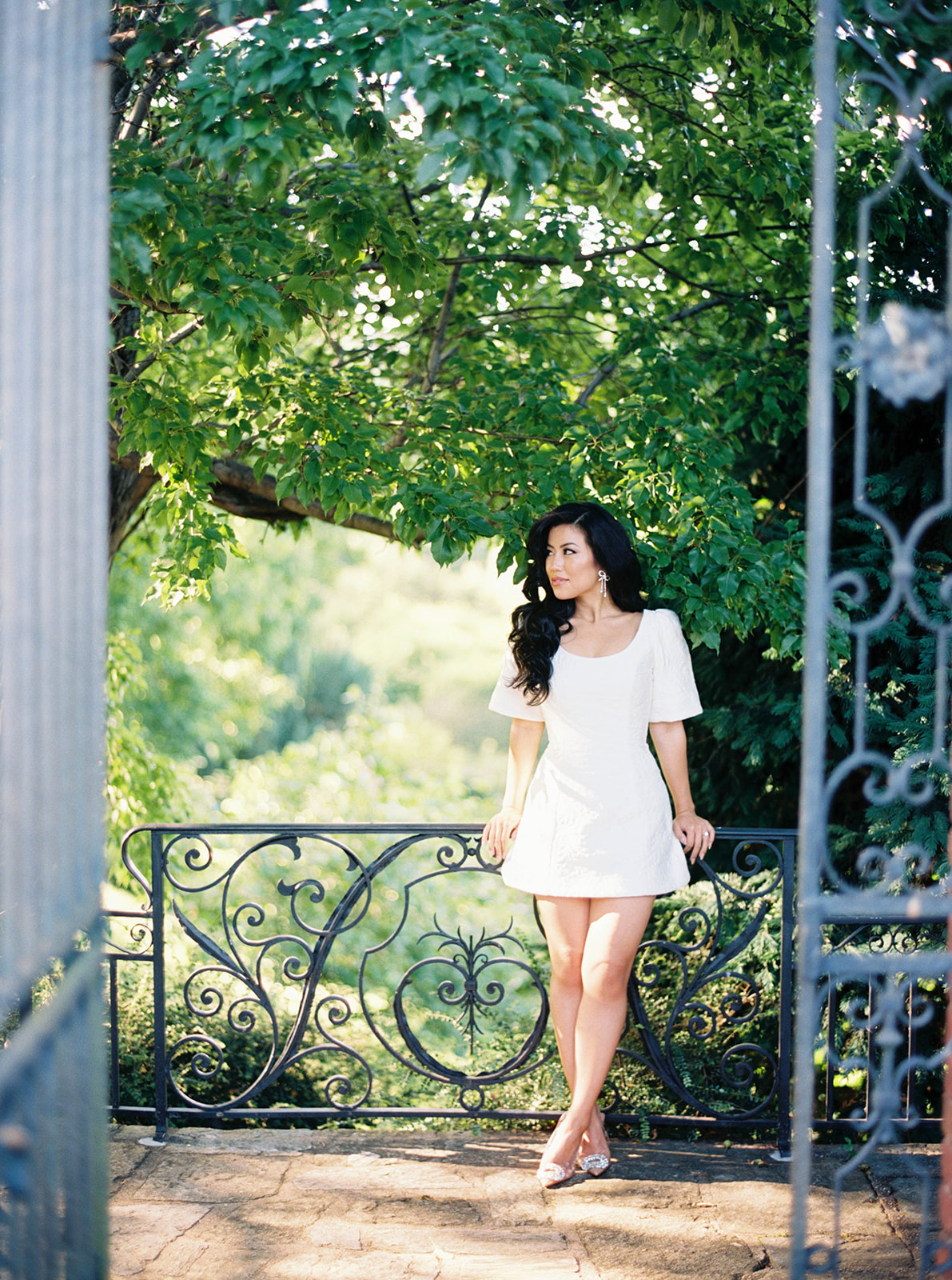 A couple poses for their engagement session in a garden.