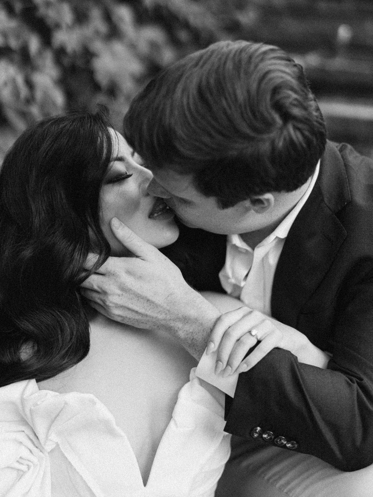 A couple poses for their engagement session in a garden.