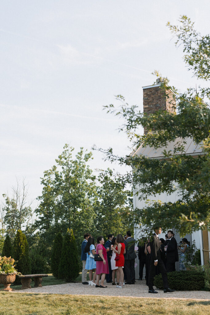 Wedding guests gathering in garden for cocktail hour at The Seclusion