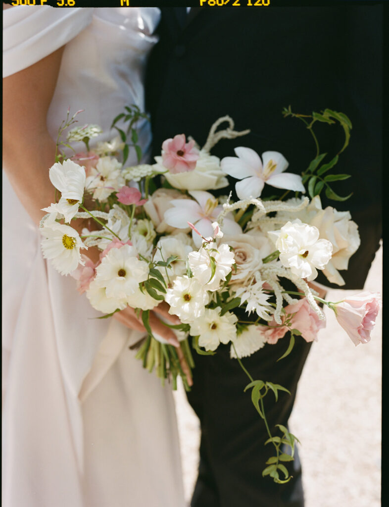 Bridal Bouquet Close-Up A soft and airy bridal bouquet with white, blush, and pale pink flowers including lisianthus and cosmos.