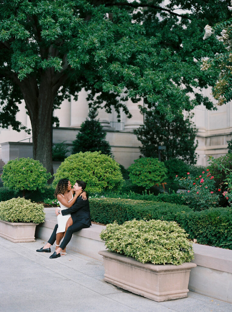 Engagement photos of a couple outside at the National Gallery of Art Museum in Washington, DC.