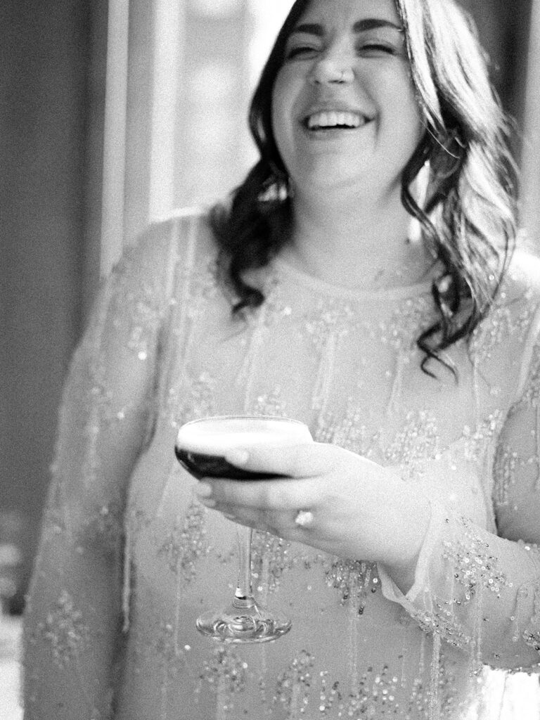Bride laughing during her engagement session at Le Diplomate in Washington, DC. Black and white photo.